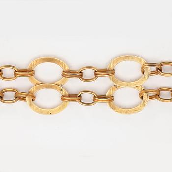 YVES SAINT LAURENT, a gold colored metal chain.