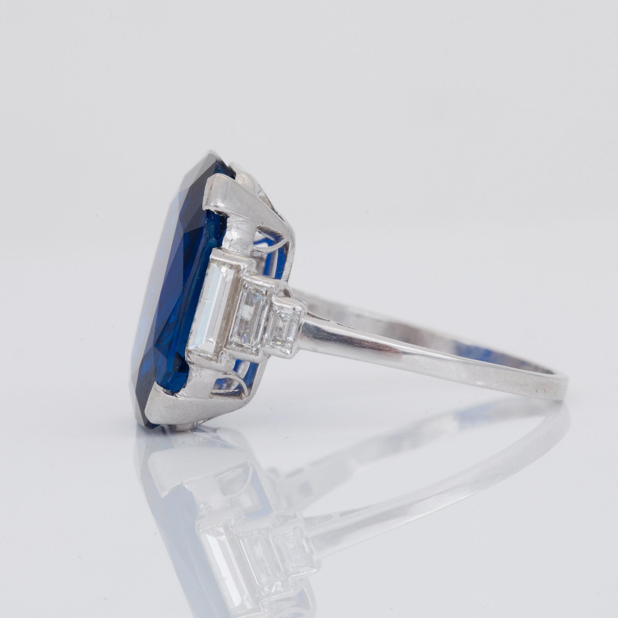 An unheated 11.27 ct Ceylon sapphire and baguette-cut diamond ring. Total carat weight of diamonds 0.70 cts.