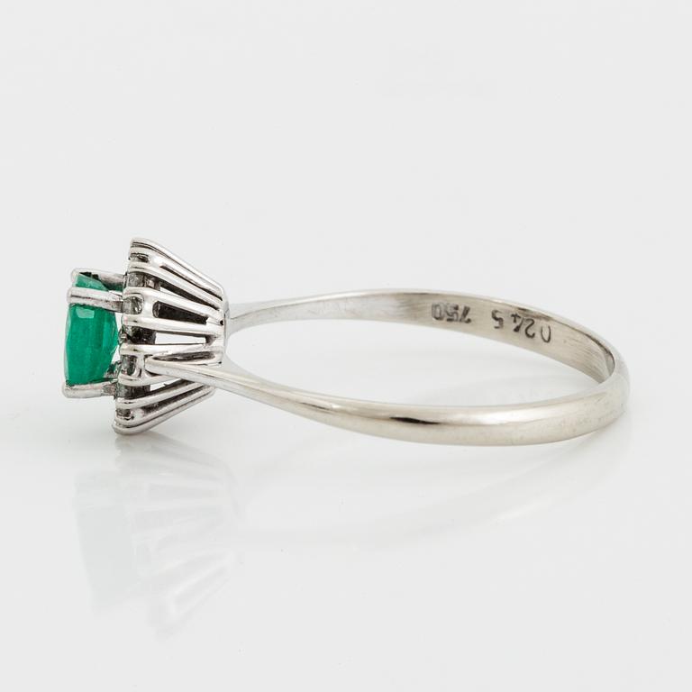 An emerald and brilliant-cut diamond ring.