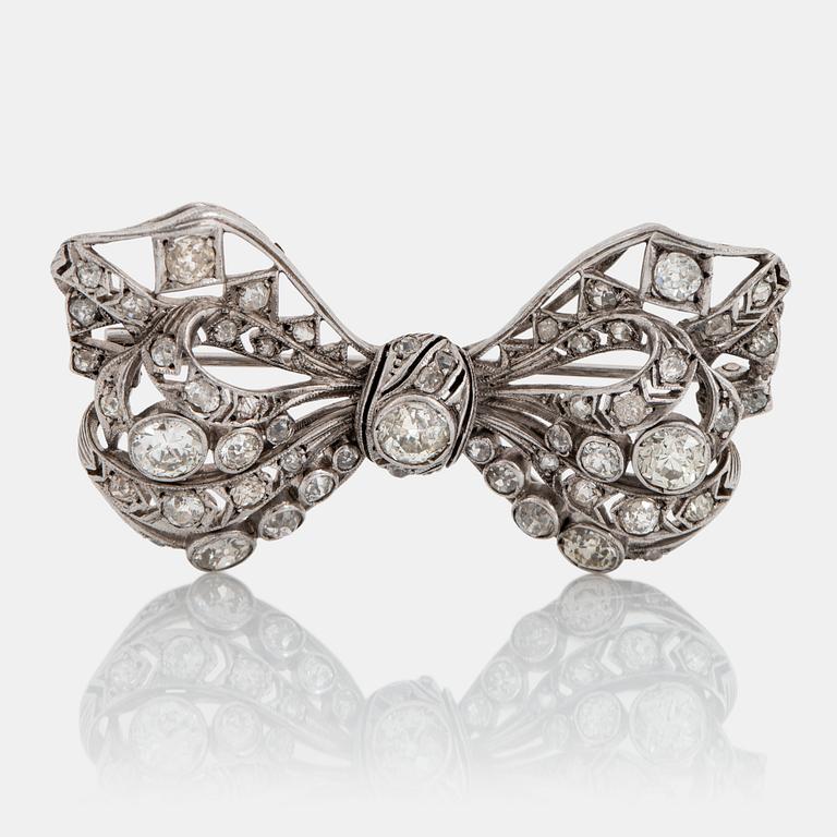 A silver bow brooch set with old-cut diamonds.