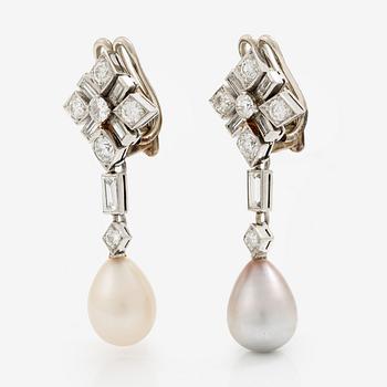 Ett par örhängen med baguette- och runda briljantslipade diamanter samt vita och gråa droppformade pärlor.