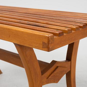 A stained-wood bench, later part of the 20th Century.