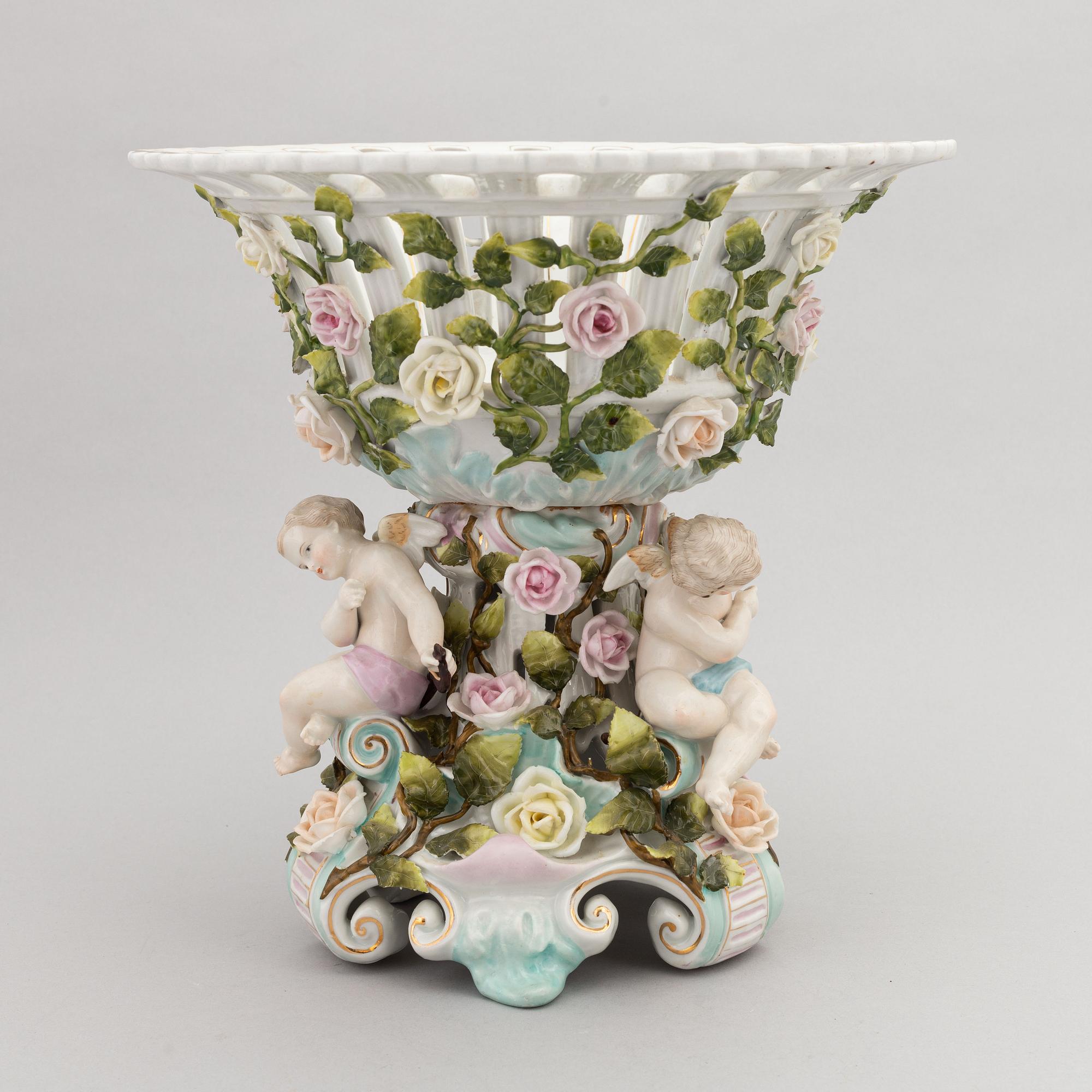 A pair of porcelain rococo style candelabra and a centerpiece bowl, Plaue, Germany, first half of the 20th century.