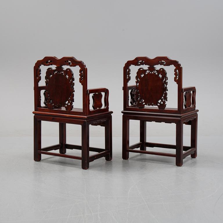 A pair of Chinese hardwood armchairs, presumably late Qing dynasty 19th century.