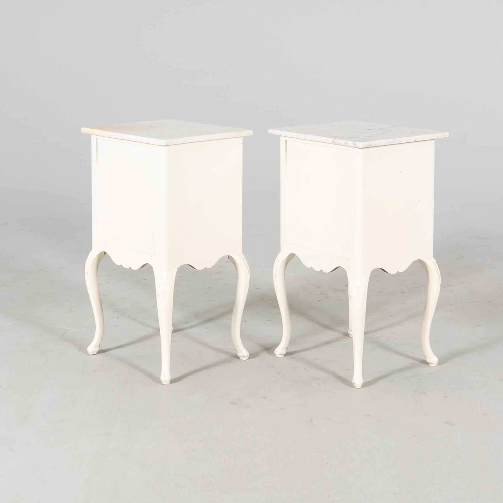 A pair of painted Rococo style bedside tables mid 1900s.