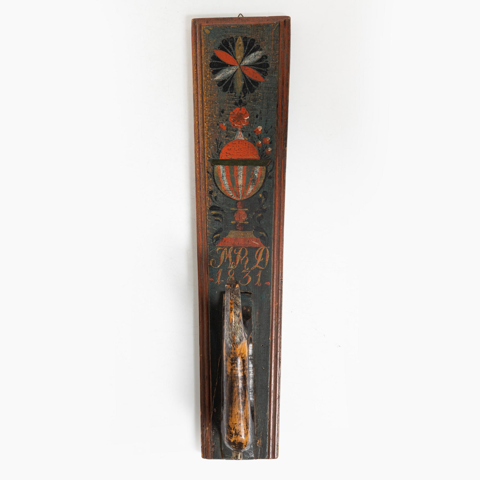 A painted wooden mangle board, dated 1831.