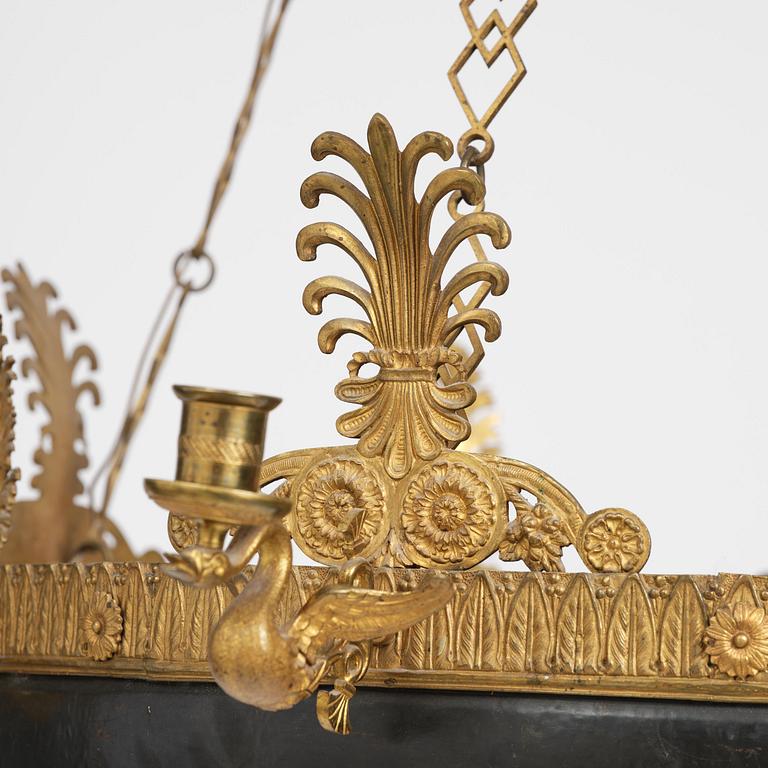 A presumably Russian Empire gilt and patinated bronze nine-branch chandelier, 19th century.