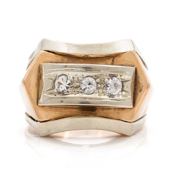 A ring set with three faceted, white stones.