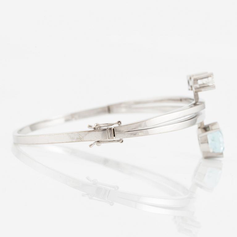 A bangle 18K white gold with aquamarine and two round brilliant-cut diamonds.