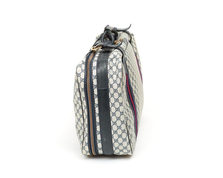 A travelling bag by Gucci.