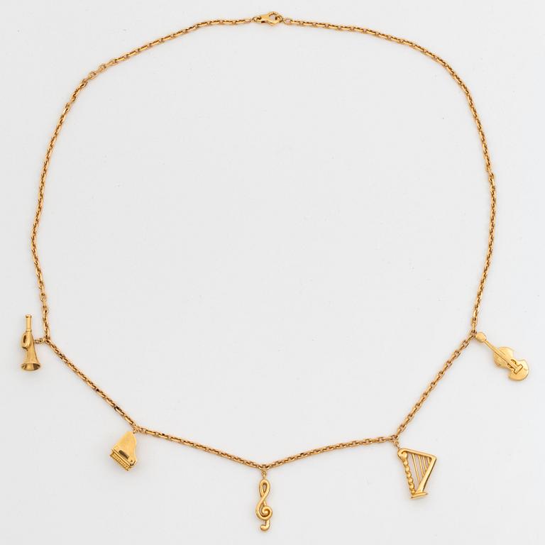 An 18K gold  Dior necklace with charms.