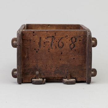 A cheese mould, dated 1768.