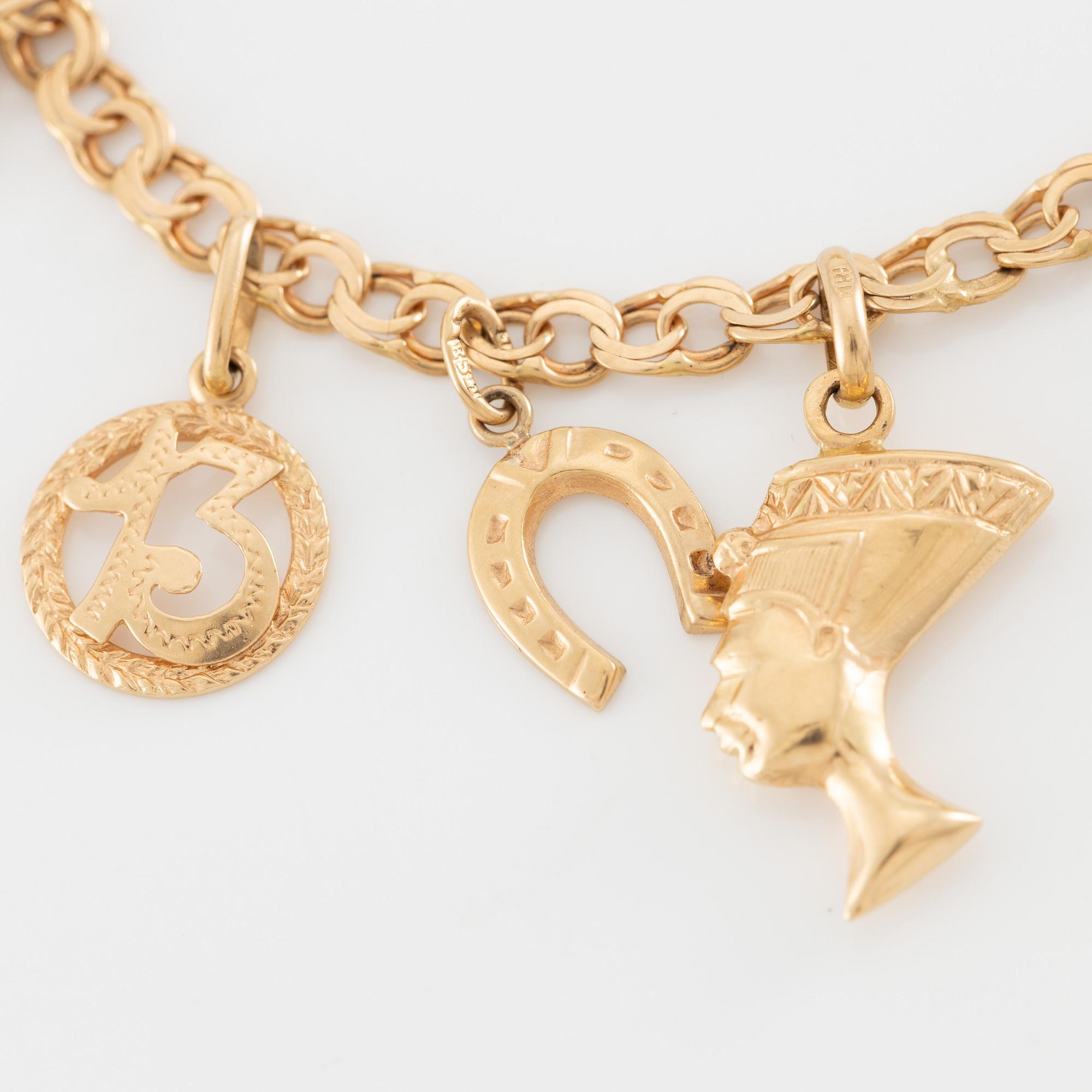 Armband 18K guld med berlocker.