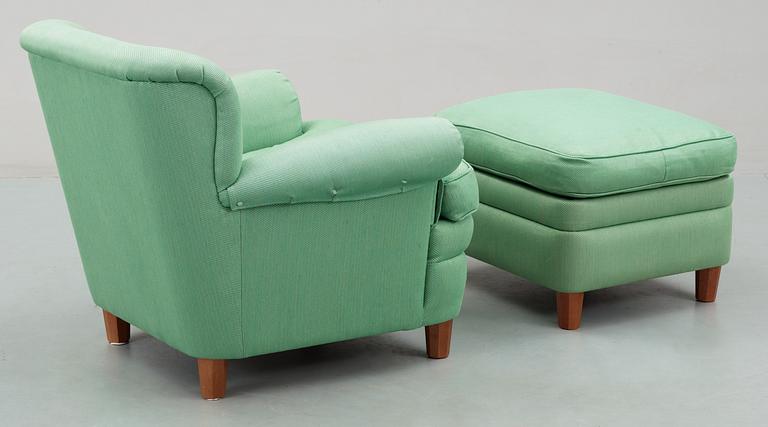 A Josef Frank armchair with ottoman, by Svenskt Tenn, model 568.