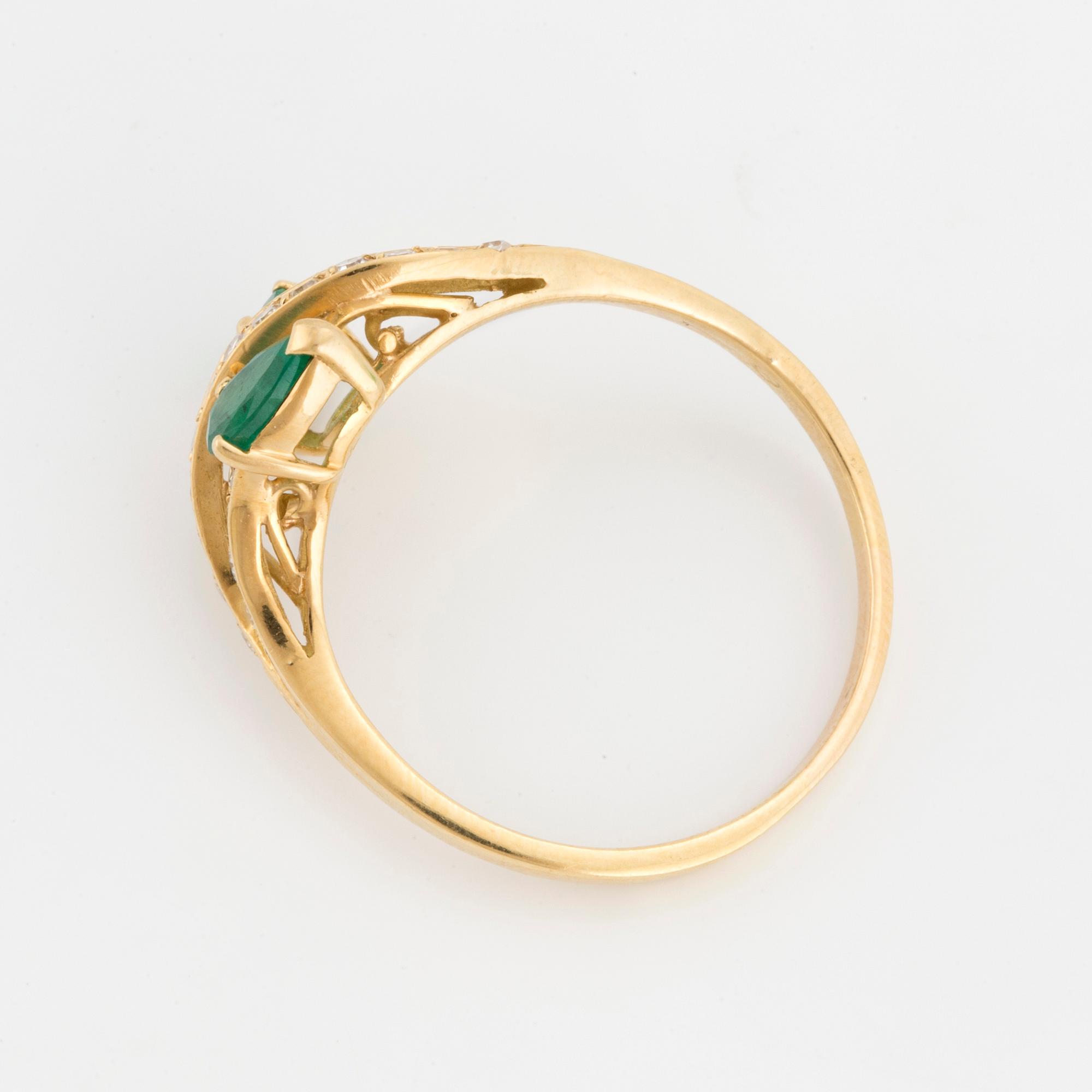 A ring set with pear-shaped emeralds and eight-cut diamonds.