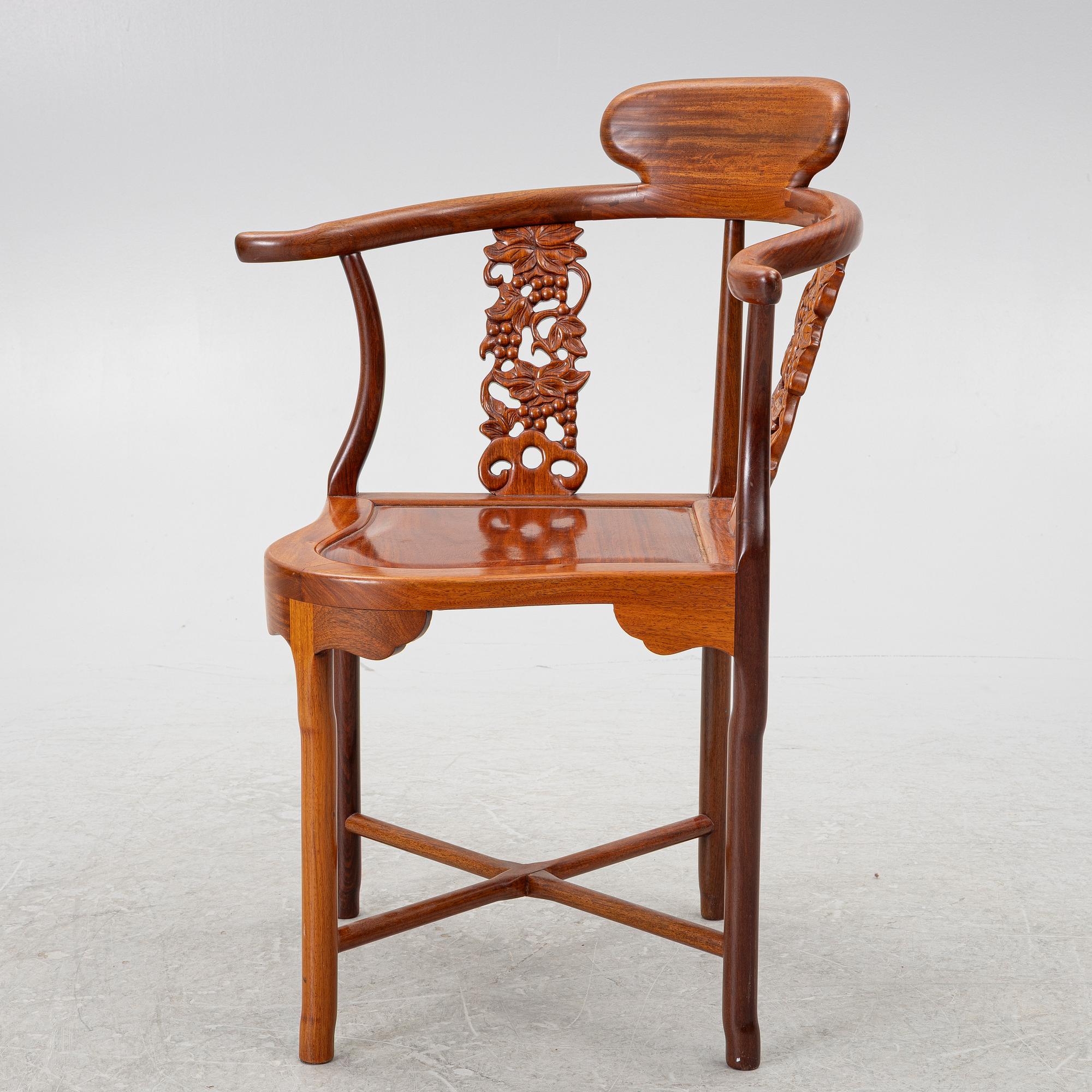 A Chinese hardwood corner armchair, 1900s.