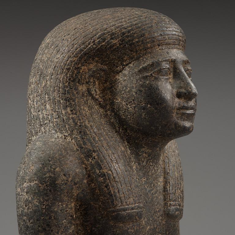 An Egyptian black granite bust of a man, 19th century or older.
