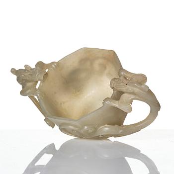 A carved nephrite cup with 'chilong' handles, late Qing dynasty/early 20th century.