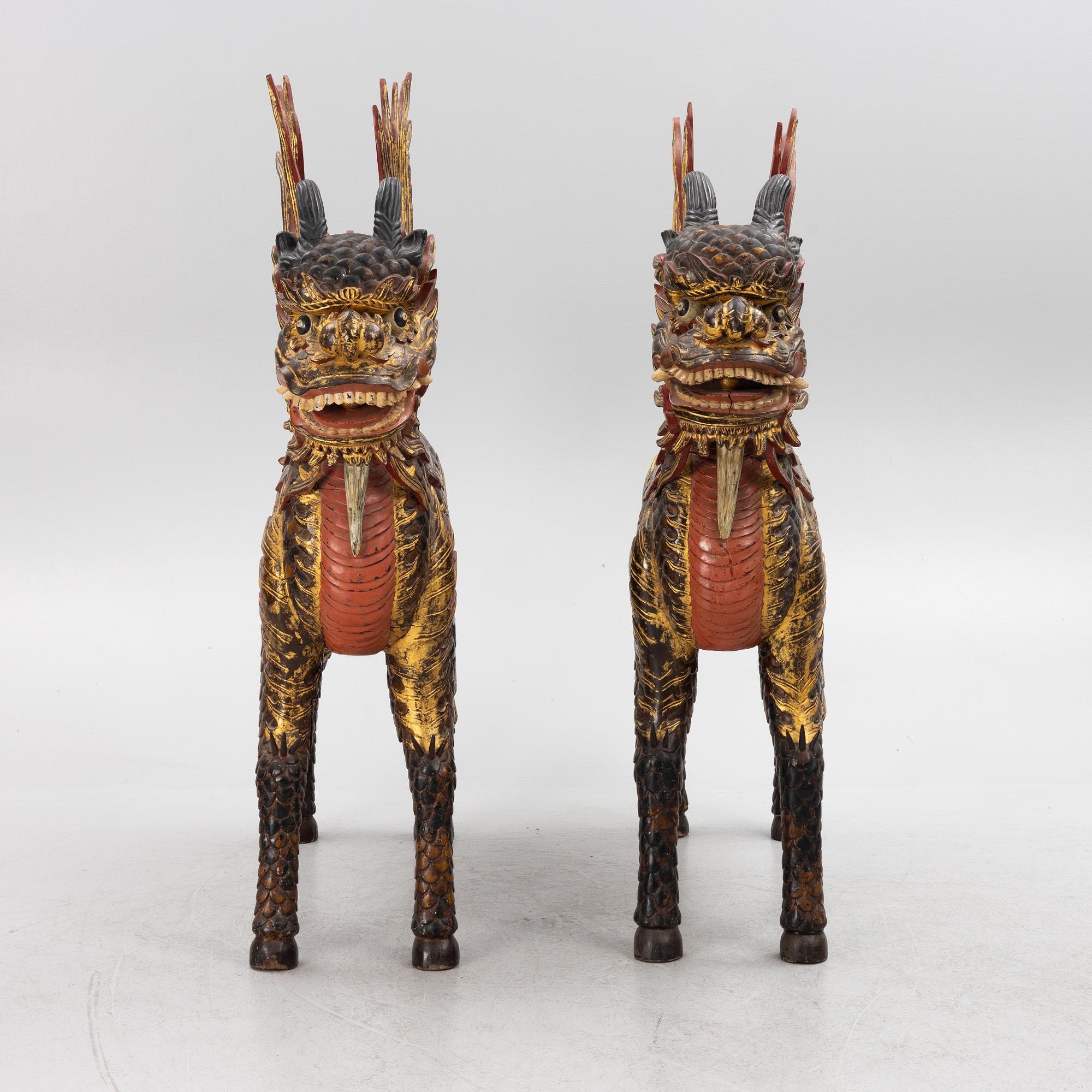 A pair of large Qilin sculptures, lacquered wood, first part of the 20th century.