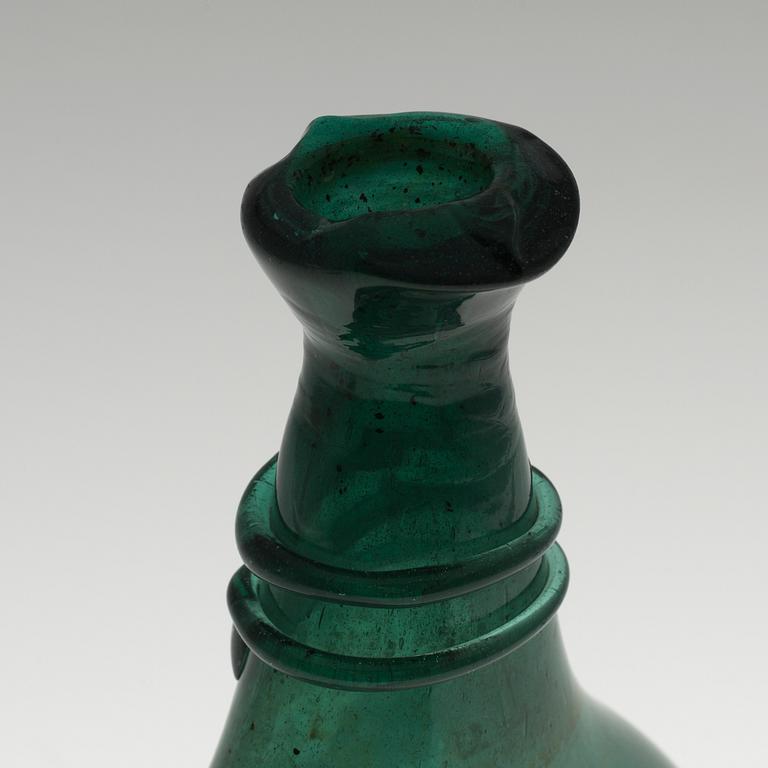 A 18th century glass bottle.