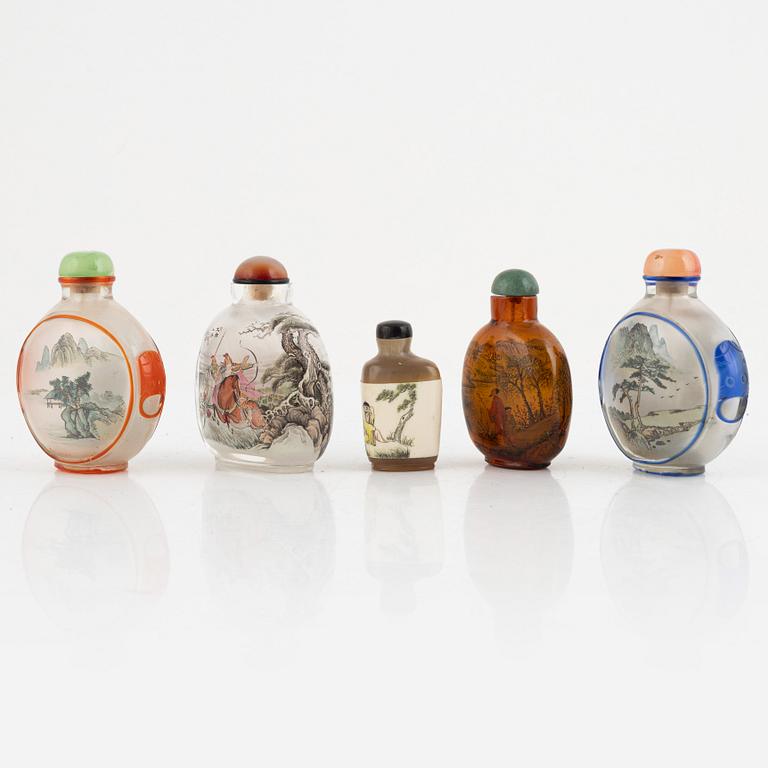 A group of five Chinese snuff bottles with stoppers, "20th Century.