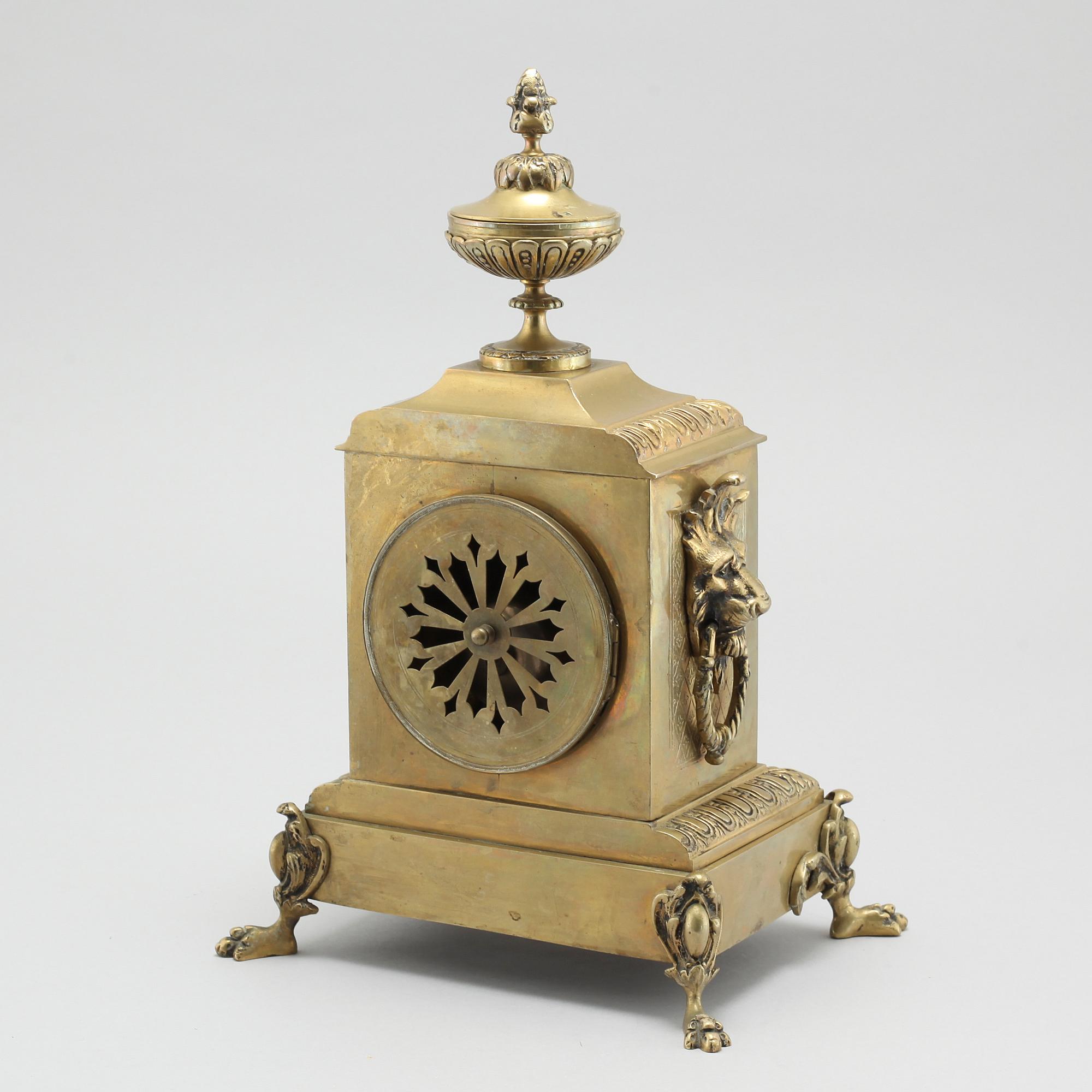 A table clock and two candelabras, around the year 1900.