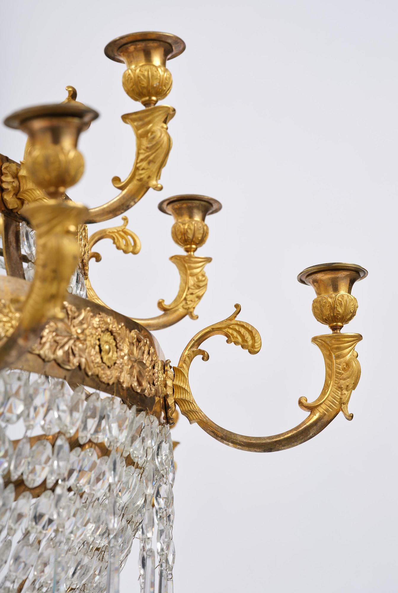 An ormolu and cut glass sixteen-branch Empire chandelier, Paris, early 19th century.