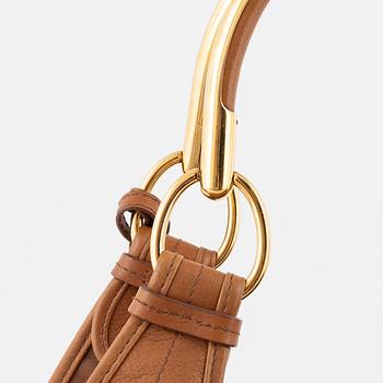 Christian Dior, a brown leather handbag.