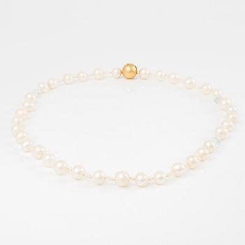 Ole Lynggaard clasp in 18K gold with a necklace of cultured freshwater pearls.