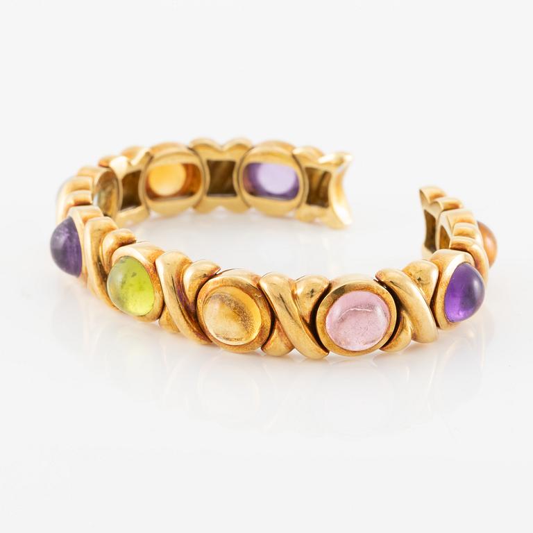 Bracelet in 18K gold set with cabochon-cut citrine, amethyst, pink tourmaline, peridot, and aquamarine.