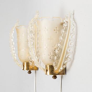 a pair of glass wall lamps from Orrefors in the mid 20th century.