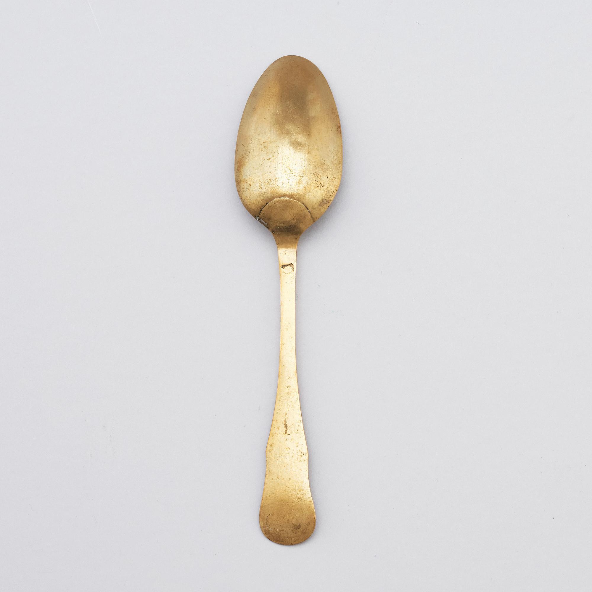 A brass (originally silver plated) spoon by Erik Castman.
