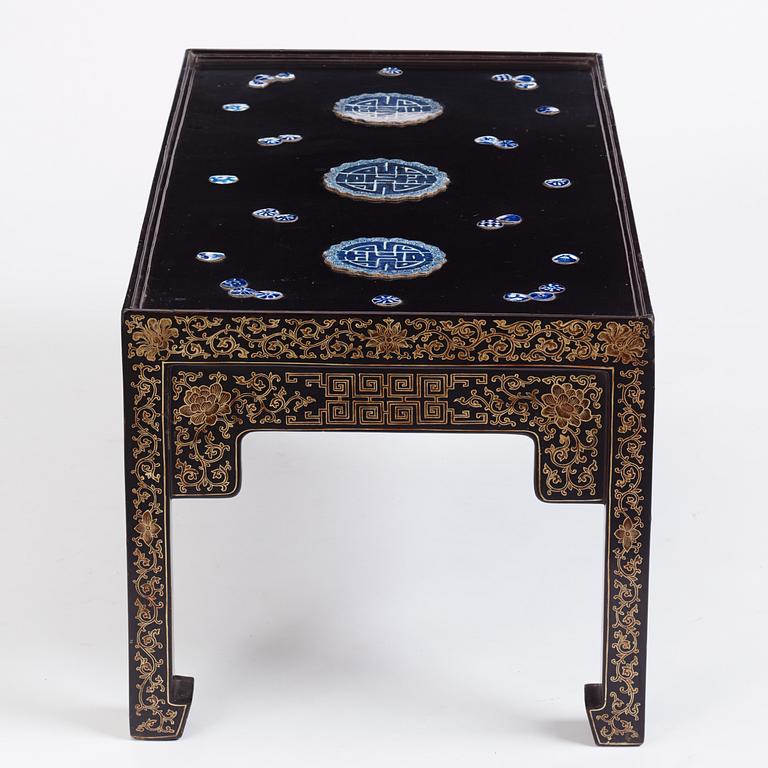 A Chinese black lacquered table with porcelain placques, presumably first half of the 20th century.