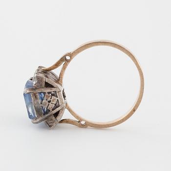 A synthetic sapphire and white gemstone ring.