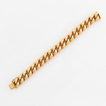 An 18K gold bracelet.