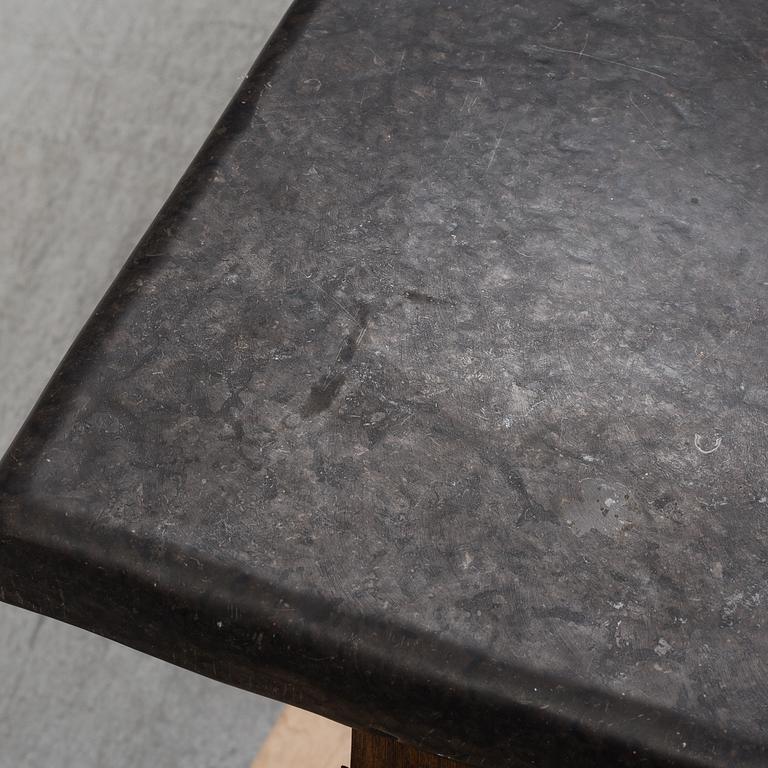 A 19th Century Baroque style table with a stone top.