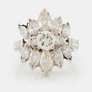 977. A platinum ring set with round brilliant-, navette- and baguette-cut diamonds.