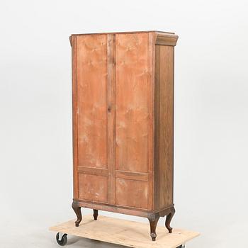 A 1920s oak display cabinet.