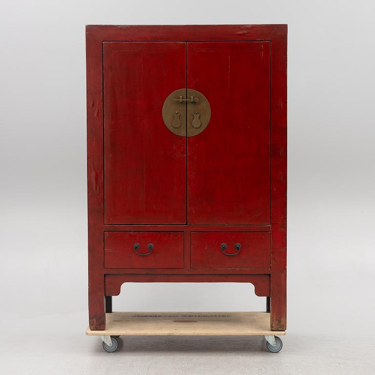 A red-lacquered cabinet, China, 20th century.