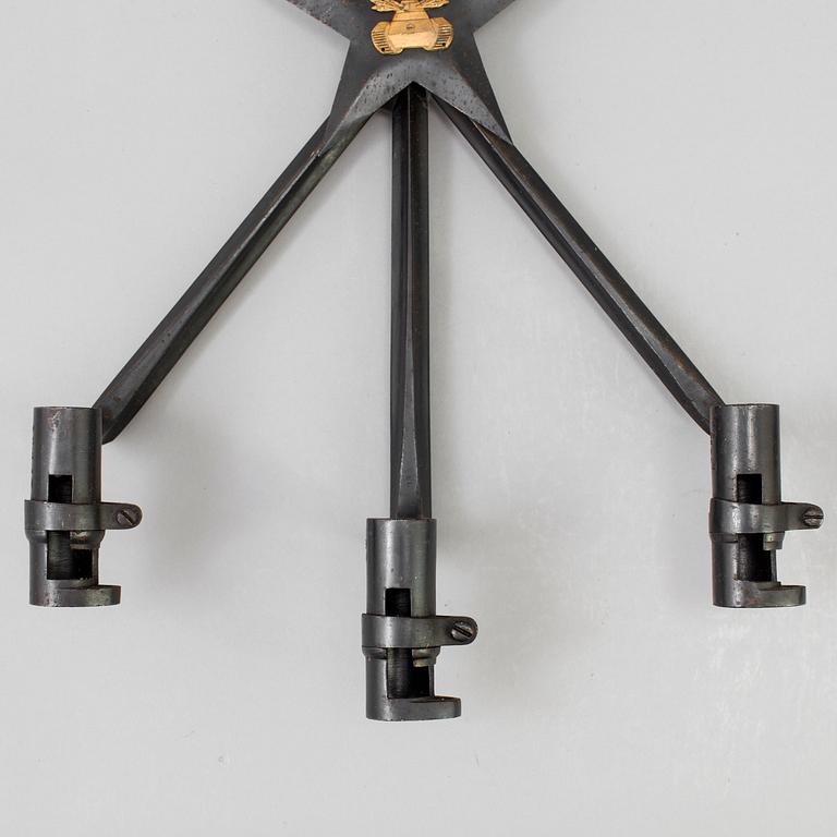 A pair of steel wall sconces made from bayonets, 20th Century.