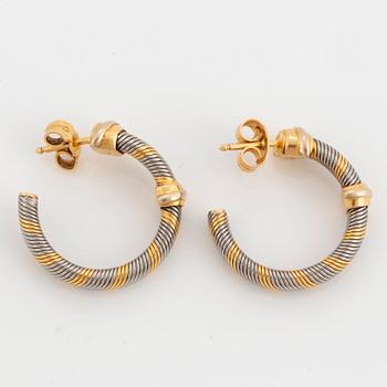 A Cartier bracelet and a pair of earrings in steel and 18K gold.