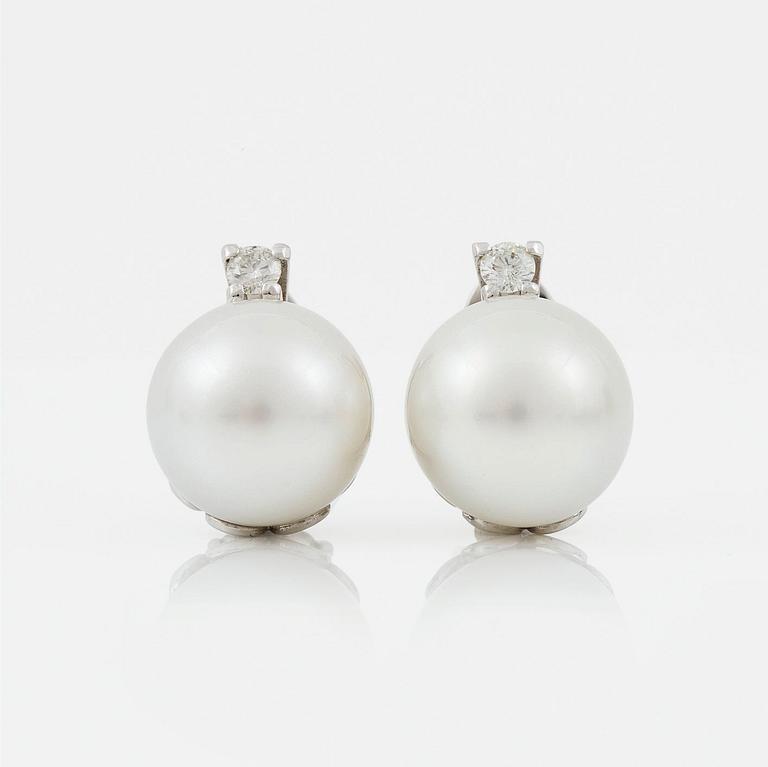 A pair of cultured South sea pearl and diamond earrings. Total carat weight of diamonds circa 0.35 ct.