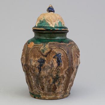 A Chinese 'Shiwan' ware pottery jar with cover, Qing dynasty, 19th century.