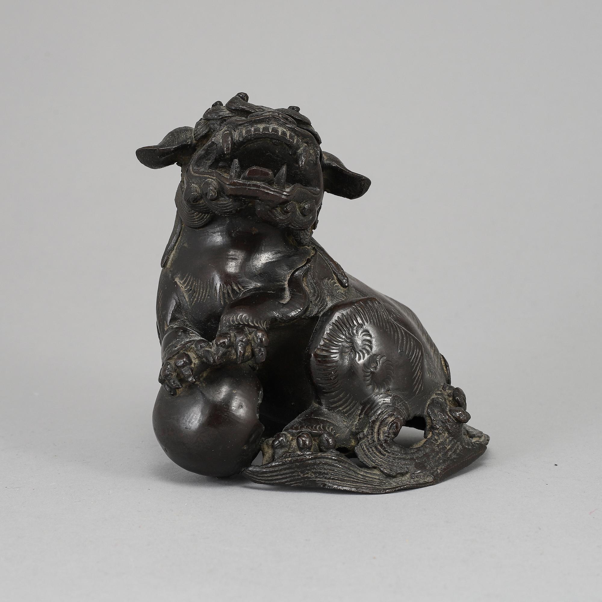 A bronze figure of a buddhist lion, Qing dynasty, circa 1900.