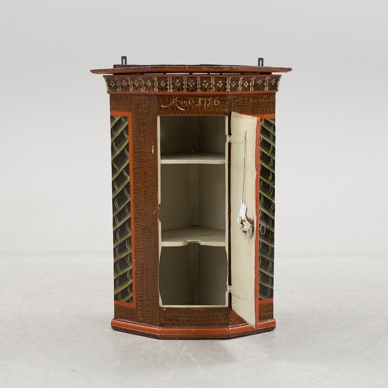 A folk art corner cabinet.