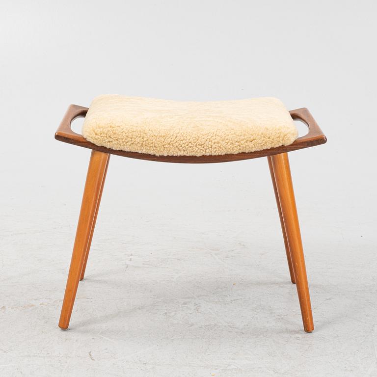 A teak stool with new sheepskin upholstery, 1960s.