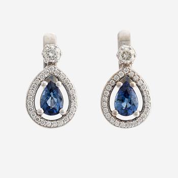 A pair of 14K gold earrings with faceted sapphires and round brilliant-cut diamonds.