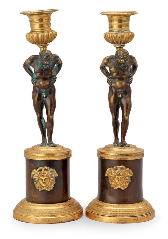 A pair of Empire early 19th century candlesticks.