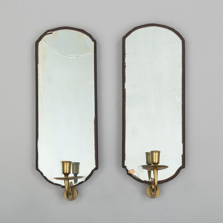 A pair of mirrors with candle sconces, partly 18th century.