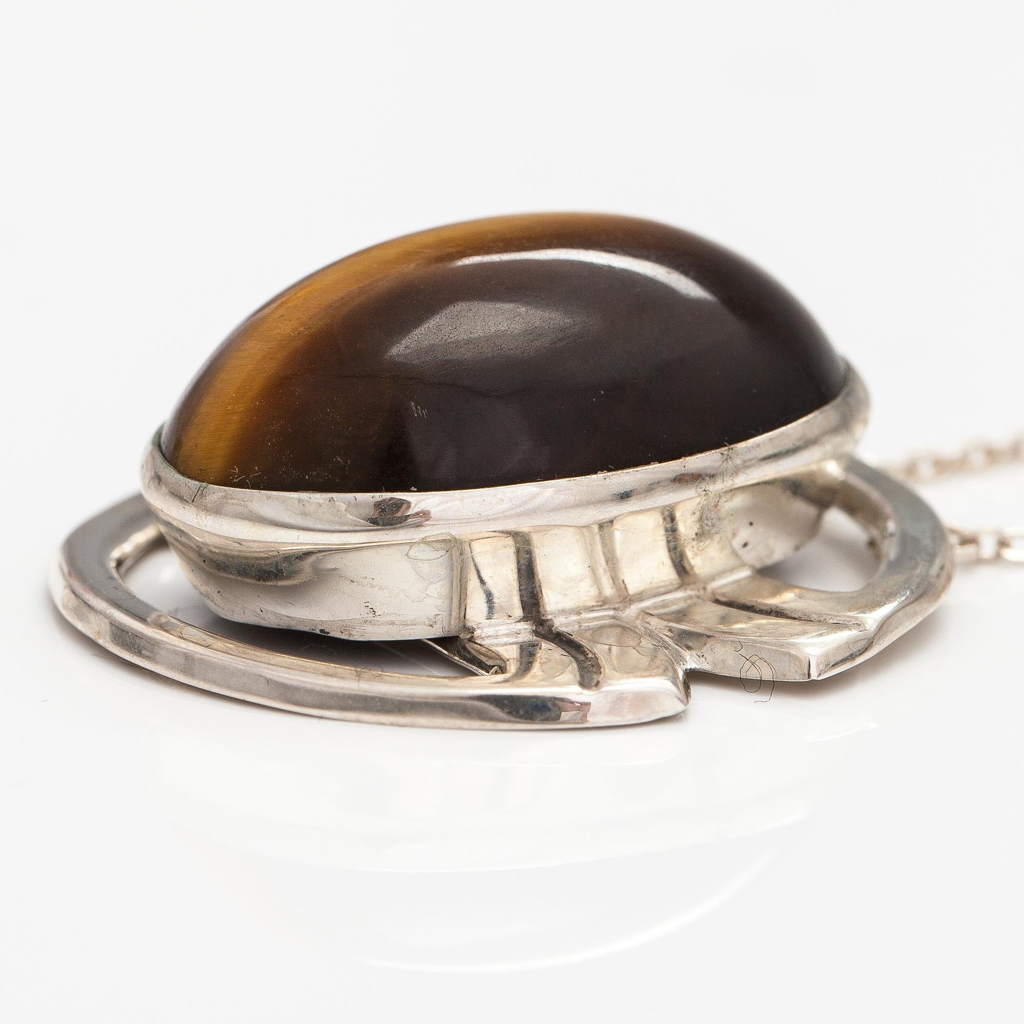 A silver ring and necklace with tiger's eye. Kultasepät Salovaara, Turku 1961.